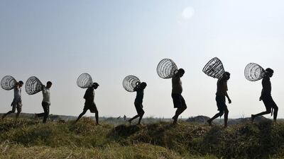 Indian fishermen with their fishing traps are on their way to take part in a community fishing on the occasion of the annual Magh Bihu festival in Morigaon district of Assam state. The festival marks the end of the winter harvesting and is celebrated on the first day of ‘Magh’ month of Assamese calendar. EPA