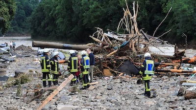 Firefighters assess debris brought by the flood after torrential rain in Schuld, Germany..