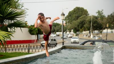 A child plays in a public fountain in Algiers. AP