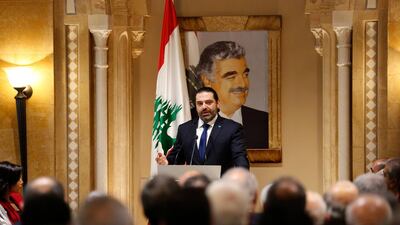 Lebanon's former prime minister Saad Hariri, speaks during a press conference. Behind him, a portrait of his late father Rafik Hariri. AP