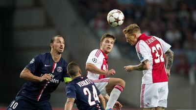 Niki Zimling, right, of Ajax duels with Zlatan Ibrahimovic, left, of Paris Saint-Germain during their Champions League match on Wednesday. Olaf Kraak / EPA