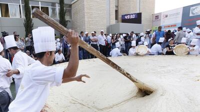 Lebanese chefs prepare hummus, during a bid to break a record previously held by Israel and reclaim ownership over the popular Middle Eastern dish, in Fanar, east of Beirut, Lebanon. A Guinness World Records adjudicator confirmed that Lebanon now holds the record. Hussein Malla / AP Photo