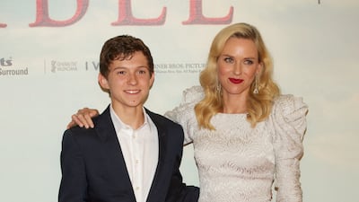 Tom Holland, in a navy suit, and actress Naomi Watts attend the 'The Impossible' premiere in Madrid on October 8, 2012. Getty Images