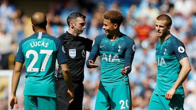 Alli speaks with referee Michael Oliver as Eric Dier and Lucas Moura look on. Reuters