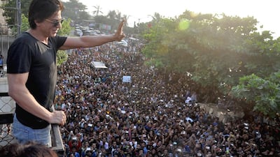 Shah Rukh Khan waves to his fans from the roof of his Mumbai villa. Red Chillies Entertainments