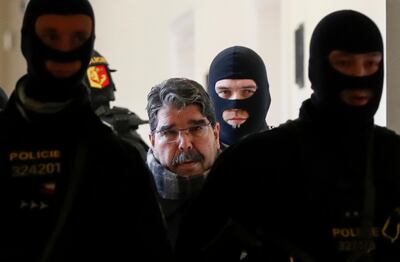 Syrian Kurdish leader Saleh Muslim, centre, is escorted by Czech police for his trial at the municipal court in Prague. AFP Photo