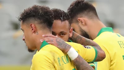 Brazil's Philippe Coutinho (L) celebrates with teammate Neymar after scoring against Bolivia. AFP