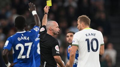 Harry Kane receives a yellow card from referee Paul Tierney. AFP