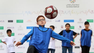 Yahya Zaher, 10, puts his football skills to the test at the National Sports Day at Zayed Sports City. Delores Johnson / The National