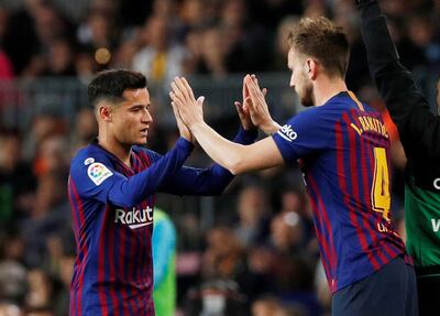 Philippe Coutinho, left, was replaced by Barcelona teammate Ivan Rakitic during the game against Rayo Vallecano. Albert Gea / Reuters