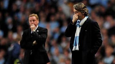 Manchester City's Roberto Mancini, right, and Tottenham's Harry Redknapp watch their teams in the final game of last season.