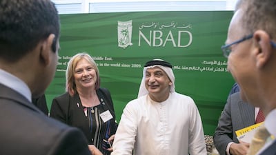 Noeleen Saeed of Abu Dhabi Holding, left, and Waheeb Ahmed Al Attar, head of multinational business corporate banking at National Bank of Abu Dhabi, centre, with other guests at the 6th Annual Global UAE Investment Forum. Silvia Razgova / The National