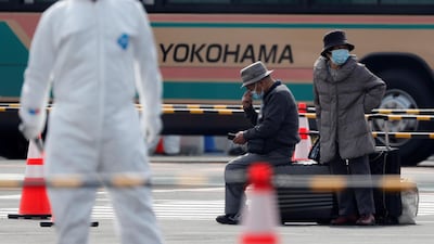 Passengers wait for transportation after leaving the coronavirus-hit Diamond Princess cruise ship docked at Yokohama Port, south of Tokyo, Japan, February 20, 2020. REUTERS/Kim Kyung-Hoon