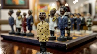 A chessboard, showing black members of South Africa’s post-apartheid government, left, including late President Nelson Mandela, centre, as the king figurine, and white members of the cabinet of apartheid-era President Pieter Willem Botha, is displayed on July 15, 2014 during an exhibition viewing before the Mandela Auction on July 17 at the Stephan Welz & Co auction house in Johannesburg. Two-hundred and two lots of Mandela memorabilia, coming from either the collection of members of the Mandela family and private collectors, will be auctioned off on July 17. Marco Longari / AFP photo