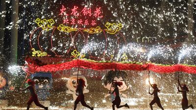 Dragon dancers perform at a park in Beijing on the fourth day of the Lunar New Year. AFP