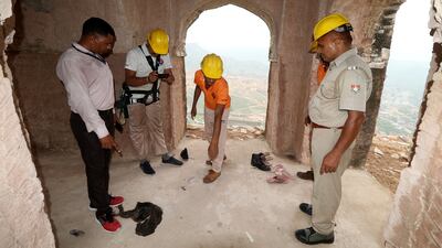Indian disaster response officers examine the scene of a lightning strike at a watch tower in Rajasthan.
