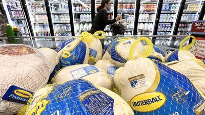 A shopper walks past turkeys displayed for sale in a grocery store ahead of the Thanksgiving holiday in Los Angeles earlier in the month. AFP