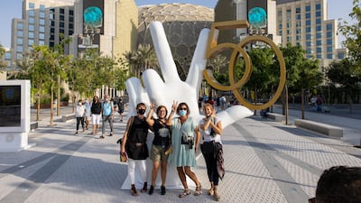 Visitors posing for a picture in front of an installation in celebration of the 50th National Day of the UAE. Image: Expo 2020 Dubai