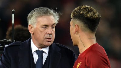 Napoli coach Carlo Ancelotti shakes hands with Liverpool forward Roberto Firmino. EPA