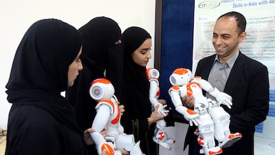 Dr Fady Al Najjar and UAEU students with the emotional robots that are being developed at Al Ain campus. Satish Kumar / The National