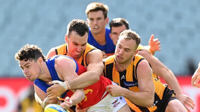 Lachine Neale of the Lions is tackled by Jonathon Ceglar and Tom Mitchell of the Hawks during the round 1 AFL match between the Hawthorn Hawks and the Brisbane Lions in Melbourne on Sunday. Getty Images