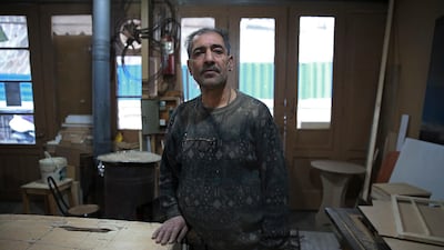 Carpenter Mohammad Reza Tajik is interviewed by The Associated Press about Iran's 1979 Islamic Revolution at his workshop, in northern Tehran, Iran. AP