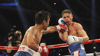Manny Pacquiao lands a punch on Chris Algieri last November in their fight in Macau, China. Pacquiao won the fight 119-103, 119-103, 120-102. Mike Young for The National / November 23, 2014