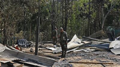 Soldiers inspect the remains of homes that were torched in Senapati, in violence from which about 23,000 people have fled. AFP