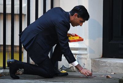 British Prime Minister Rishi Sunak lights a candle for Diwali in Downing Street. Getty Images