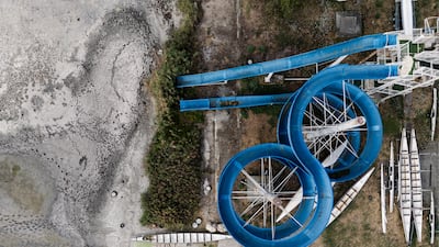 A closed water slide and exposed lakebed during a heat wave on Lake Velence, Hungary. Bloomberg