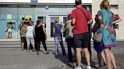People line up to withdraw cash from an ATM outside a National Bank branch in Iraklio on the island of Crete on June 28, 2015, as fears about Greece’s economiy grew. Stefanos Rapanis / Reuters