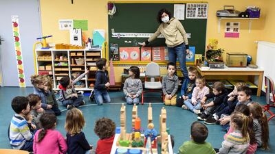 French teacher Melanie Giret, speaks to pupils in her classroom. AFP