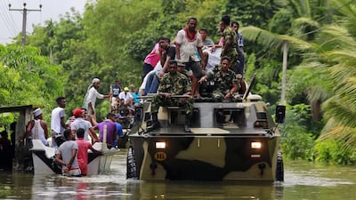 Sri Lankan soldiers evacuate flood victims and give out relief material, at a flooded area in Wehangalla village in Kalutara district, Sri Lanka, on Saturday, May 27, 2017. Sri Lanka has appealed for outside help as dozens were killed in floods and mudslides and dozens of others remain missing. Eranga Jayawardena / AP