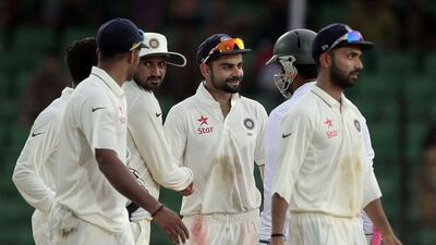 India captain Virat Kohli, center, shakes hand with Bangladesh’s Tamim Iqbal, second right, at the end of their cricket test match in Fatullah, Bangladesh, Sunday, June 14, 2015. Match ended with a draw. (AP Photo/A.M. Ahad)