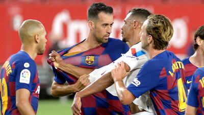 Barcelona's Spanish midfielder Sergio Busquets argues with Sevilla's Brazilian midfielder Fernando. AFP