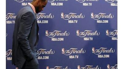 James walks into the interview room to answer questions