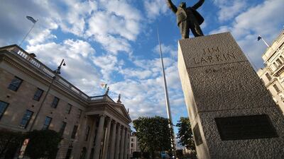 O'Connell Street with Jim Larkin Statue in the foreground, the General Post Office to the left and the Spire in the background. Courtesy Dublin Regional Tourism Authority