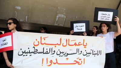 Protesters hold a banner reading in Arabic: 'Lebanese, Syrians and Palestinians workers of Lebanon, unite!' during a protest against the raids and arrests by the Ministry of Labour targeting undocumented workers. EPA