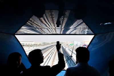 Passengers take pictures during a trip on the Dubai Metro. Jaime Puebla / The National