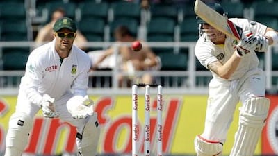 Australia's captain Michael Clarke, right, plays a shot as South Africa's wicketkeeper Mark Boucher looks on during the second day of the second test cricket match at the Wanderers stadium in Johannesburg, South Africa