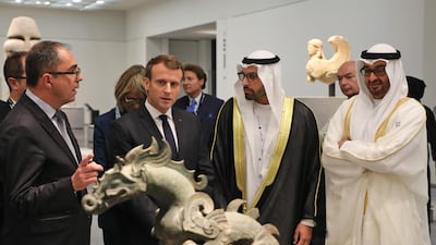 President-Director of the Louvre Museum, Jean-Luc Martinez (L) speaks to French President Emmanuel Macron (2L), Chairman of Abu Dhabi's Tourism and Culture Authority, Mohamad Khalifa al-Mubarak, Deputy Director of the Louvre Abu Dhabi (2R) and Abu Dhabi Crown Prince Mohammed bin Zayed Al-Nahyan as they visit the Louvre Abu Dhabi Museum. Ludovic Marin / AFP