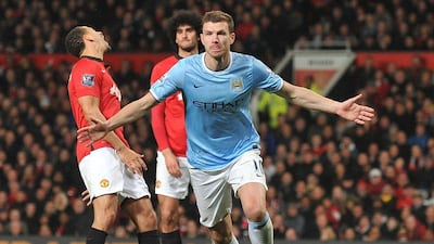 Edin Dzeko is shown celebrating following a goal against Manchester United in March. The striker signed a new four-year deal with Manchester City on Wednesday, August 20. Paul Ellis / AFP / March 25, 2014