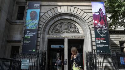 Pedestrians walk past the entrance to the National Portrait Gallery in central London. AFP