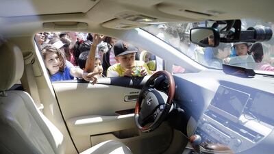 Children look inside the self-driving car at Google headquarters in Mountain View, California. AP Photo