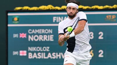 Nikoloz Basilashvili of Georgia hits a backhand return to Cameron Norrie of Great Britain. AFP