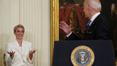 US Women’s National Soccer Team player Megan Rapinoe reacts as she is acknowledged by Mr Biden. Reuters