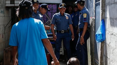 Philippine police prepare to talk to a person of interest (front left) during an anti-drugs operation at a local community in Quezon City, east of Manila, on January 29, 2018. Rolex Dela Pena / EPA