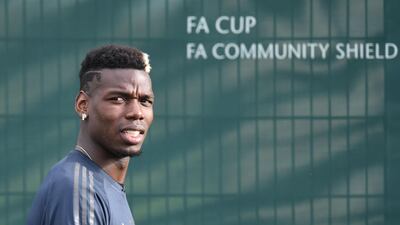 Manchester United's French midfielder Paul Pogba arrives for a training session at the Carrington Training complex in Manchester. AFP
