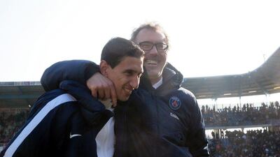 Paris Saint-Germain’s French head coach Laurent Blanc celebrates with Argentinian midfielder Angel Di Maria after winning over Troyes during the French Ligue 1 football match on March 13, 2016 at the Aube Stadium in Troyes. Paris Saint-Germain clinched a fourth consecutive Ligue 1 title in record time on March 13 after defeating Troyes, obliterating a new French record for the quickest league victory with eight games to spare before the end of the L1 championships. AFP / JACQUES DEMARTHON
