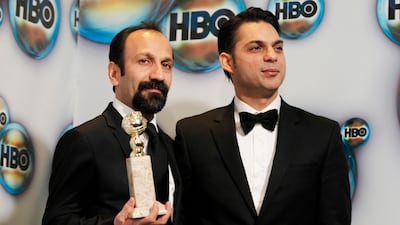Director Asghar Farhadi (L) and actor Peyman Moadi pose with the award for best foreign film for "A Separation" as they arrive at the HBO after party after at the 69th annual Golden Globe Awards. REUTERS/Danny Moloshok